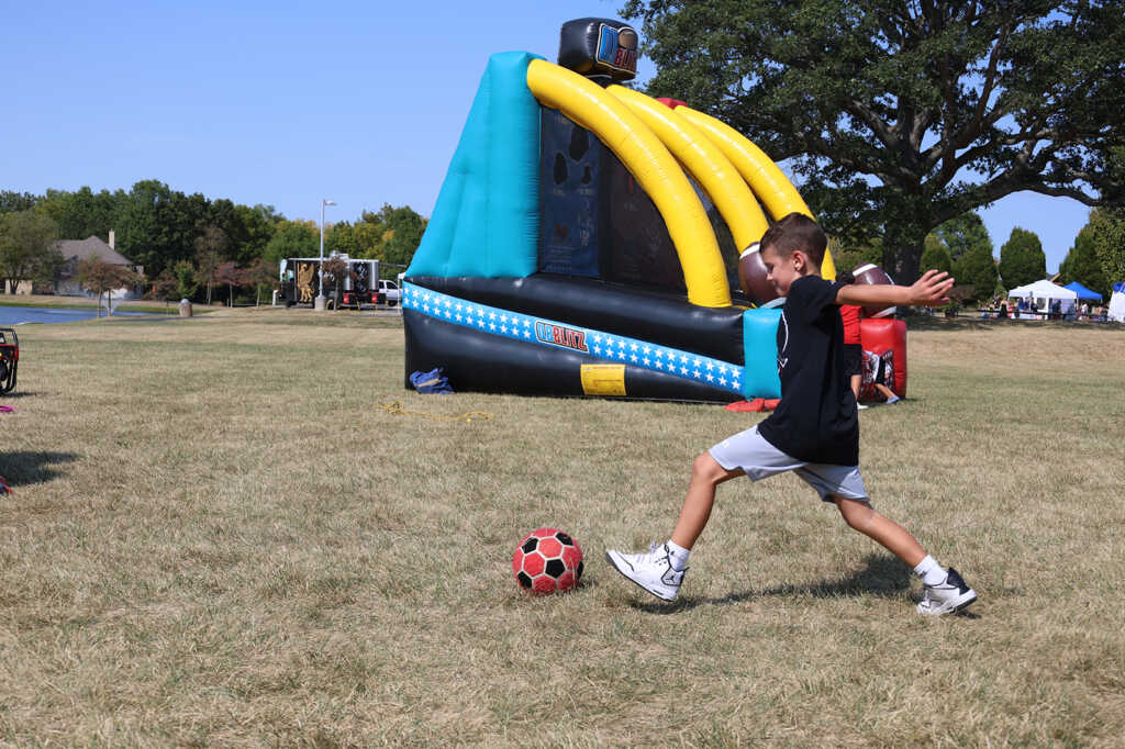 kid kicking a soccer ball